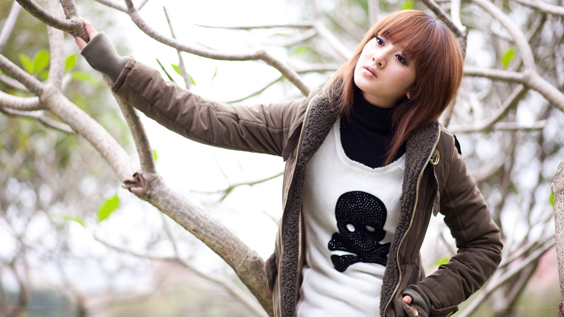 woman in jacket by tree