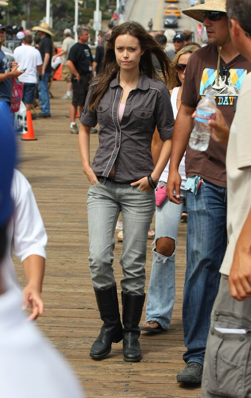 Woman in jeans and boots on a boardwalk