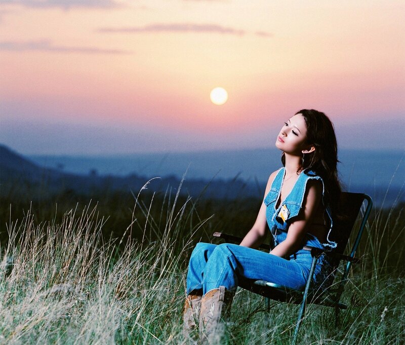 Woman in jeans at sunset