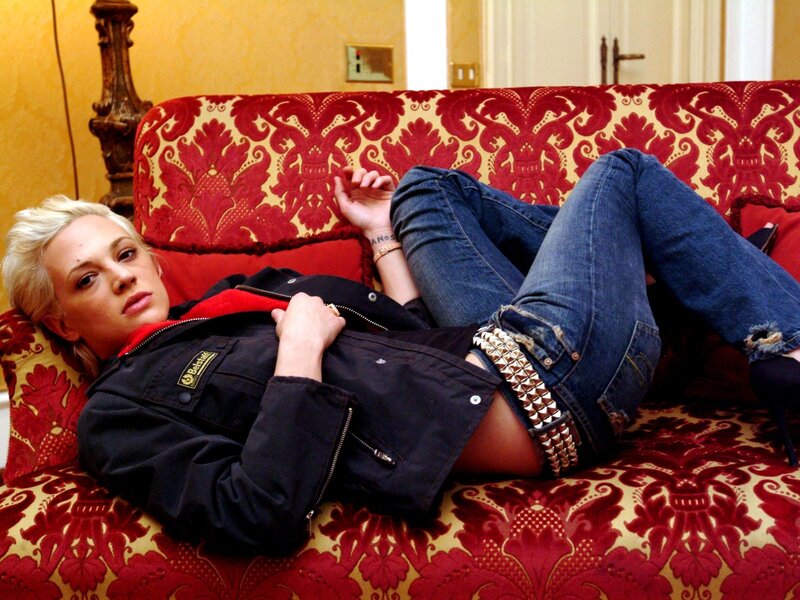 Woman in jeans on a red couch
