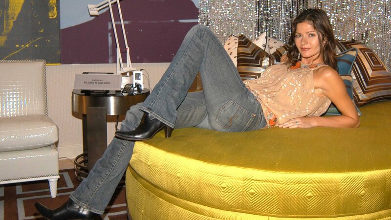 woman in jeans on yellow couch