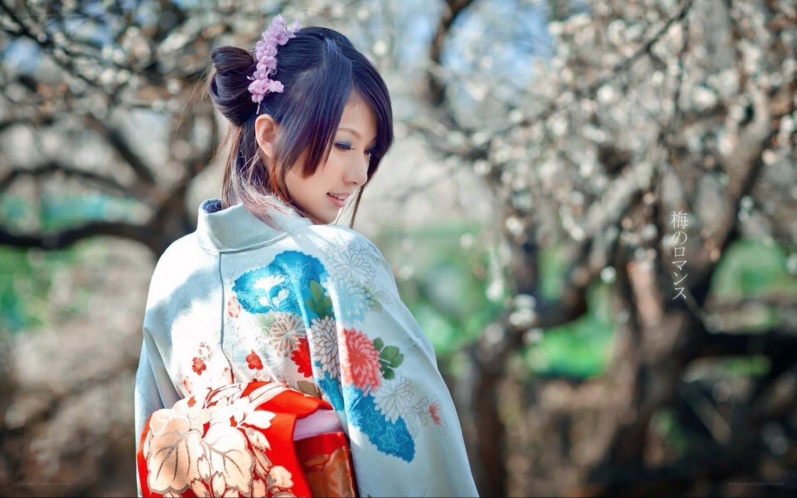 Woman in kimono among blossoms