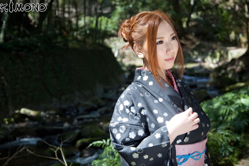 Woman in kimono by stream