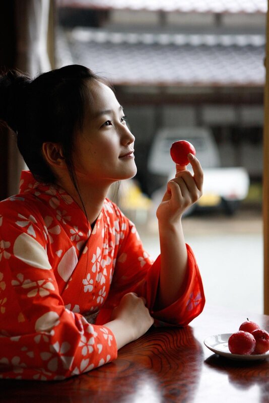 woman in kimono holding apple