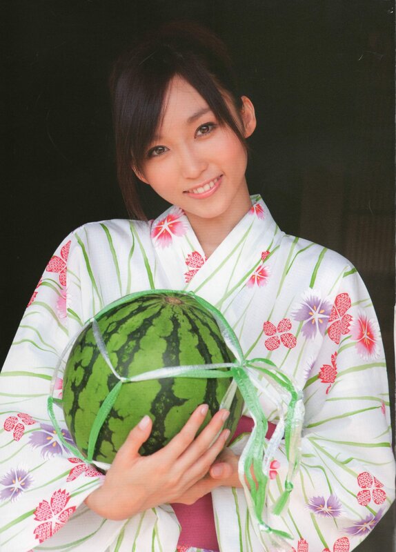 Woman in kimono holding watermelon