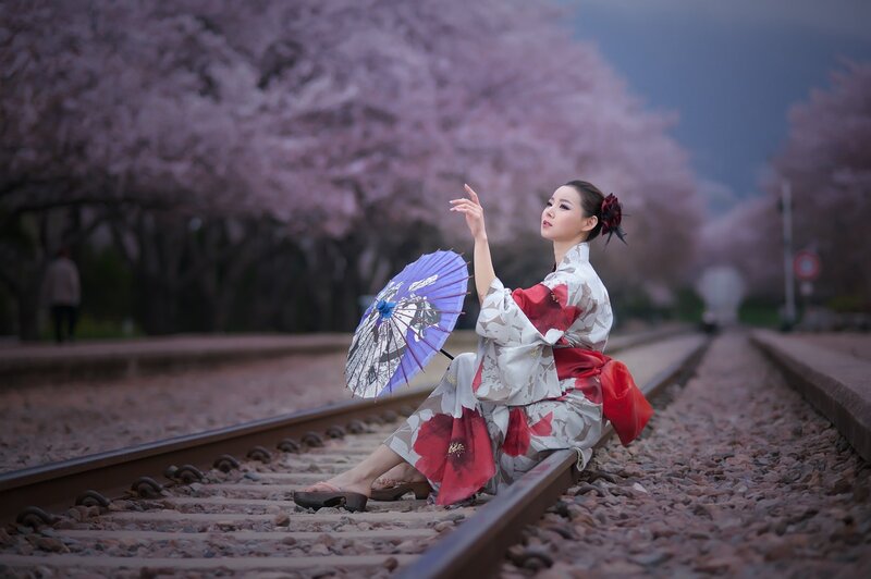 Woman in kimono on train tracks