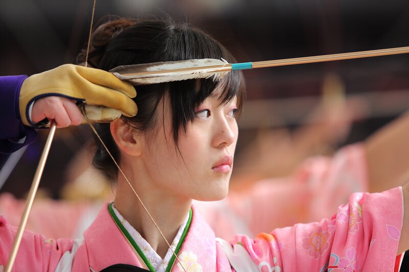 Woman in kimono shooting bow
