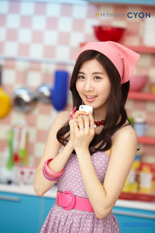 woman in kitchen holding phone
