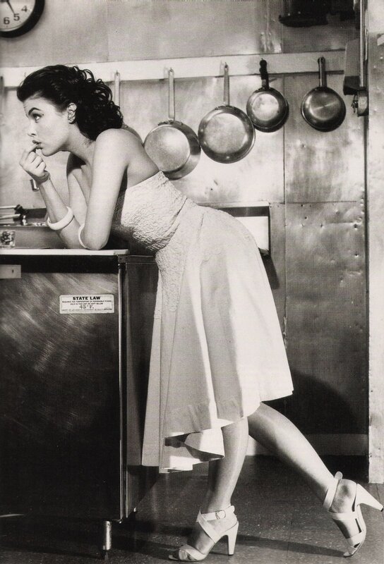 woman in kitchen leaning on counter