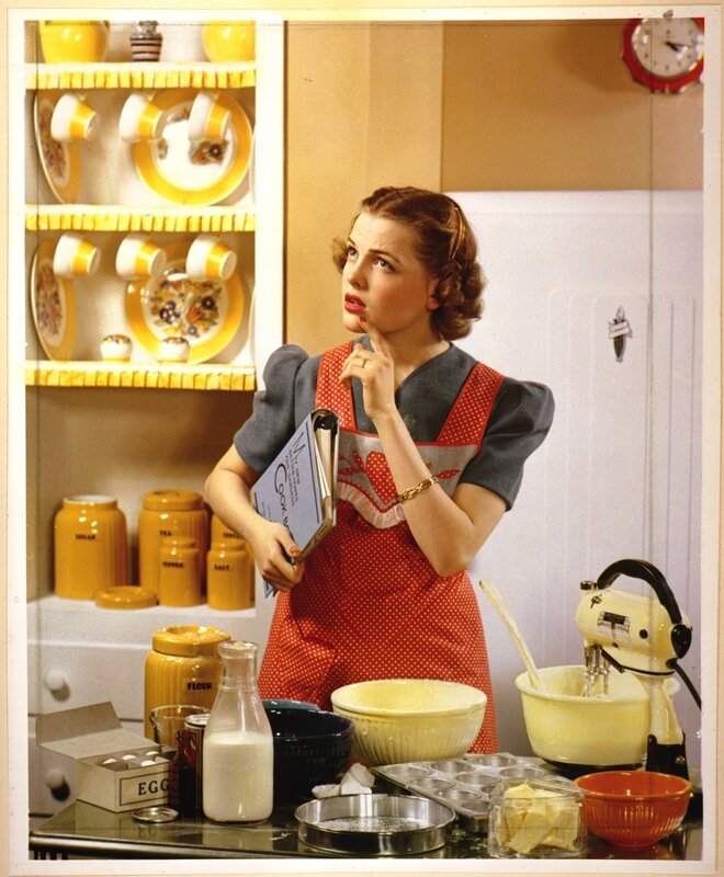 Woman in kitchen with cookbook