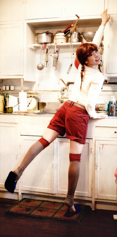 woman in kitchen with red shorts