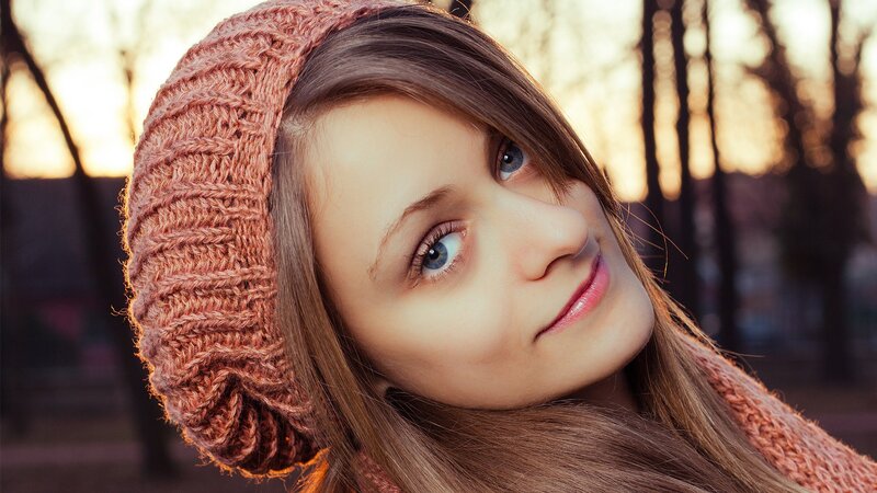 woman in knit hat at sunset