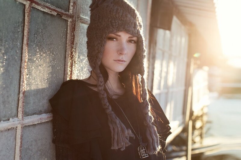 woman in knit hat at sunset