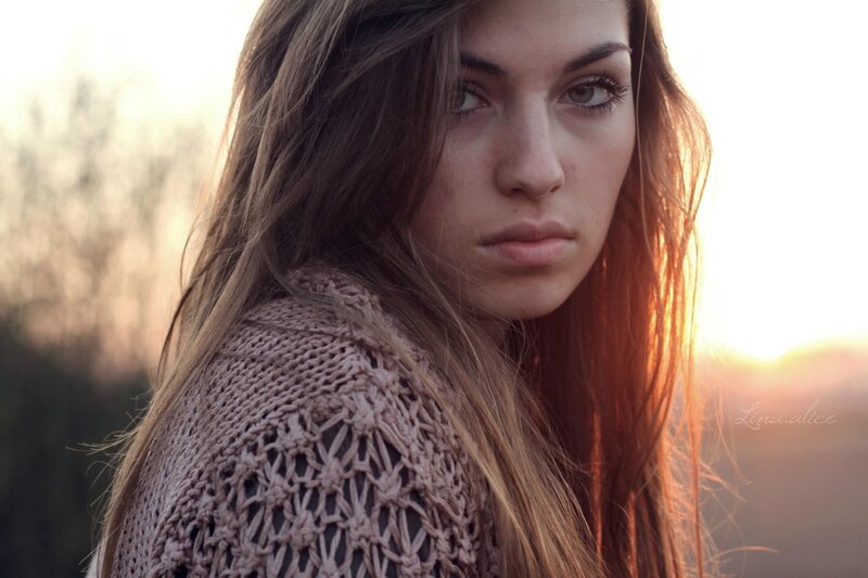 woman in knit sweater at sunset