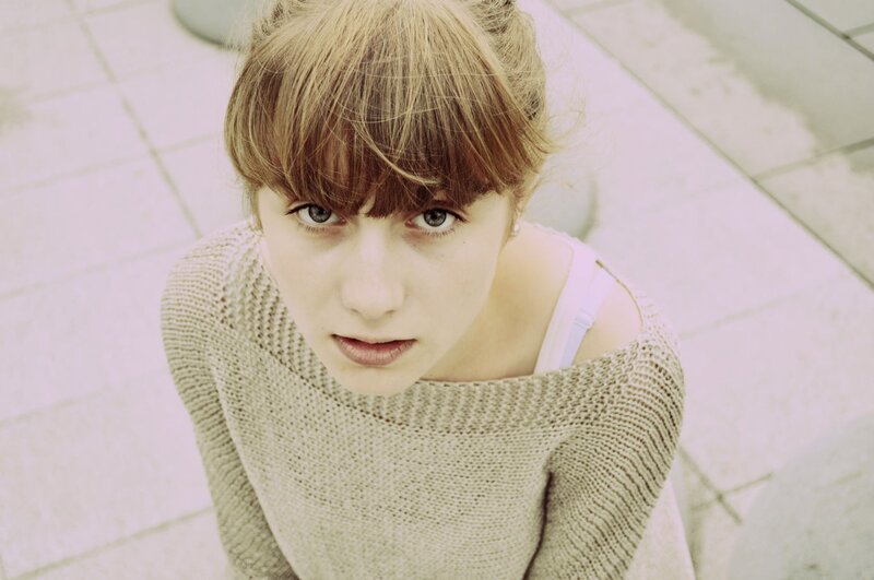 woman in knit sweater looking up