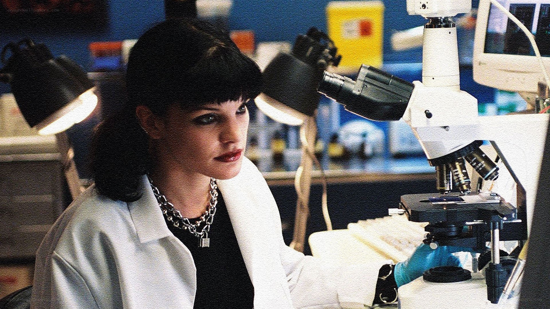 woman in lab with microscope