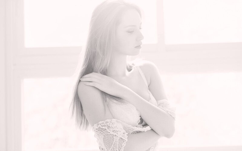 woman in lace by window