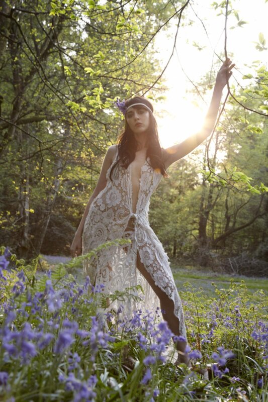 Woman in lace dress among bluebells