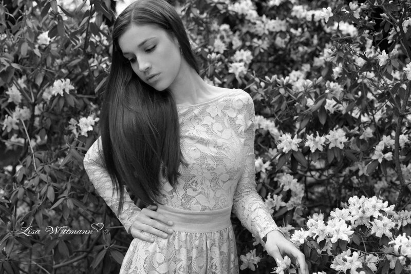 woman in lace dress among flowers