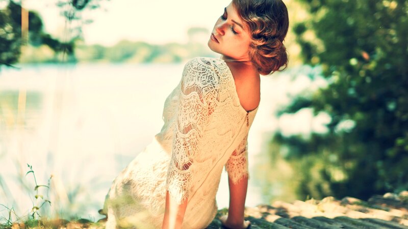 woman in lace dress by lake