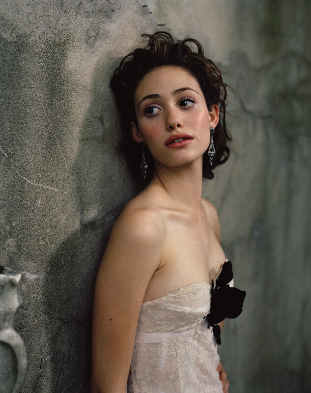 woman in lace dress leaning against wall