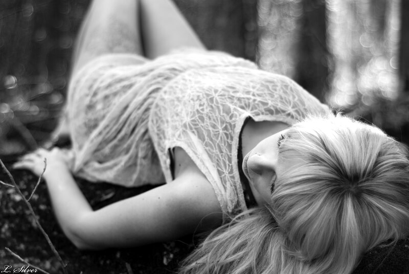 woman in lace dress lying down