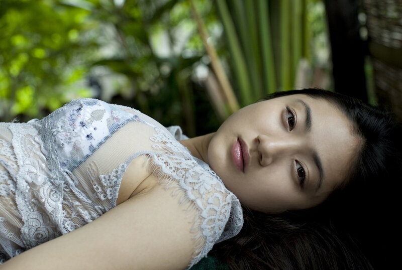 woman in lace dress lying down