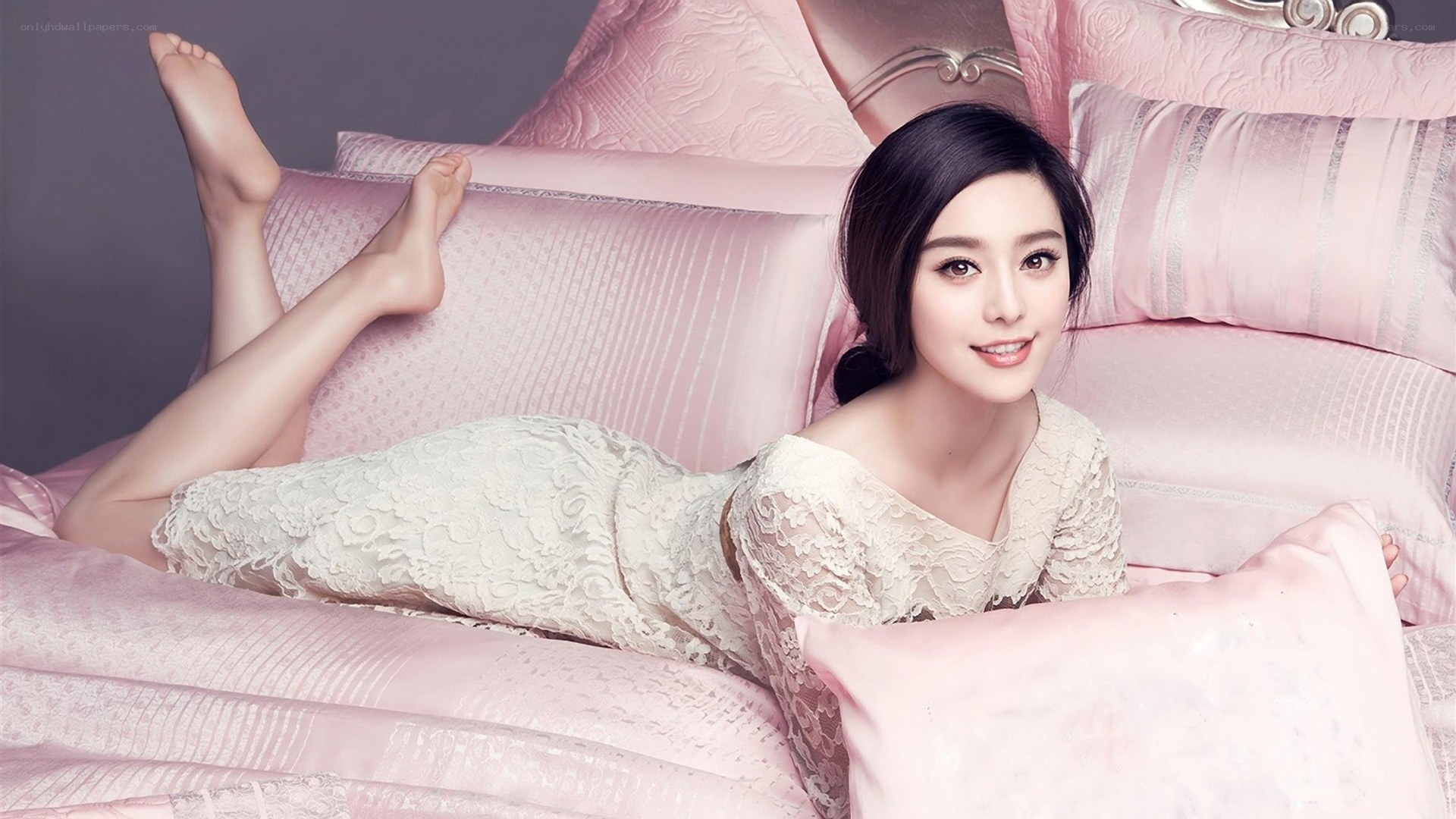 woman in lace dress on pink bed