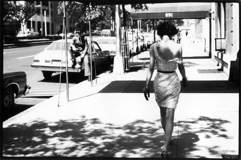 Woman in lace dress walking on sidewalk