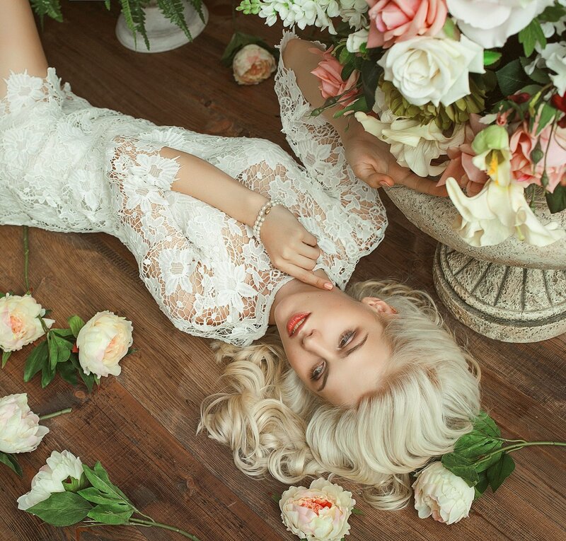 Woman in Lace Dress — White, Serene, Photograph, Flowers, Wood Floor