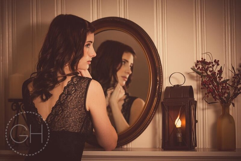 woman in lace looking at mirror