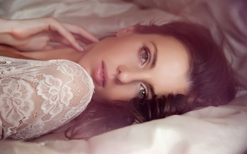 woman in lace lying on bed