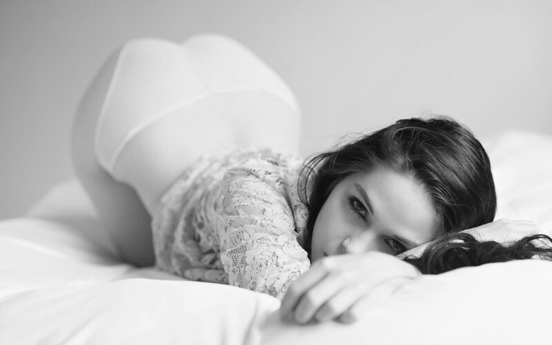 woman in lace lying on bed