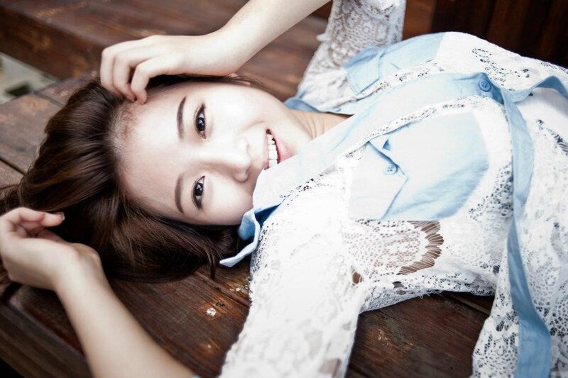 woman in lace shirt lying down