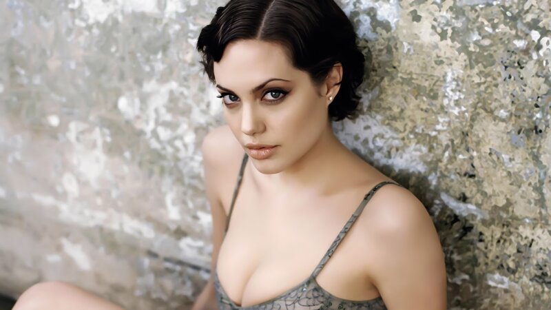 woman in lace top against wall