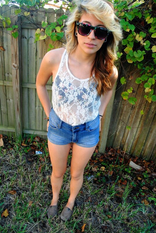 woman in lace top and denim shorts