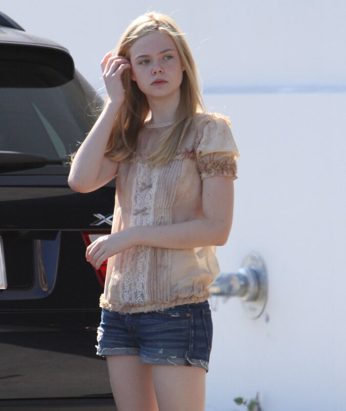 woman in lace top and denim shorts