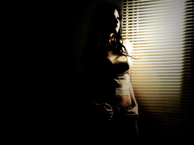 woman in lace top by window