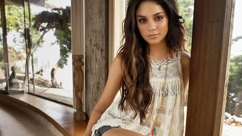 woman in lace top by window