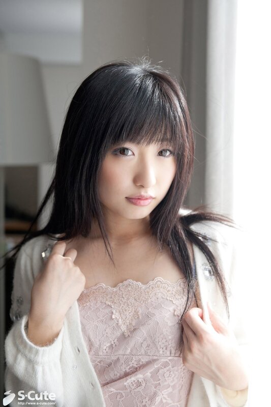 woman in lace top by window