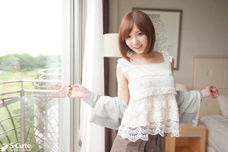 woman in lace top by window