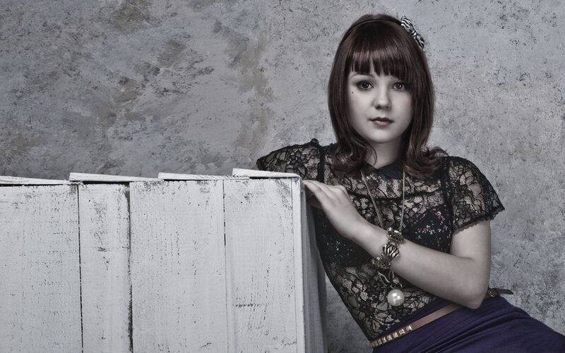 woman in lace top leaning on crate