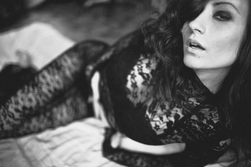 woman in lace top lying down