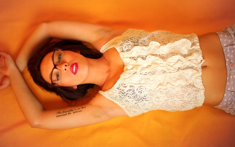 woman in lace top lying down