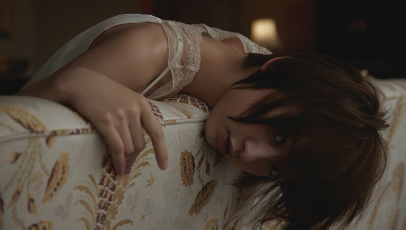 woman in lace top on couch