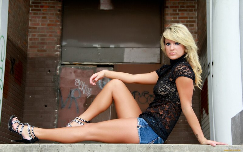 woman in lace top sitting on step