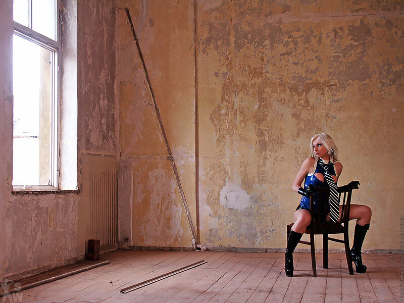 Woman in latex suit sitting