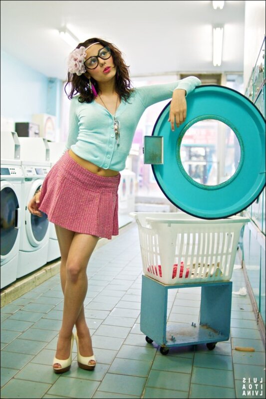 Woman in laundromat with laundry basket