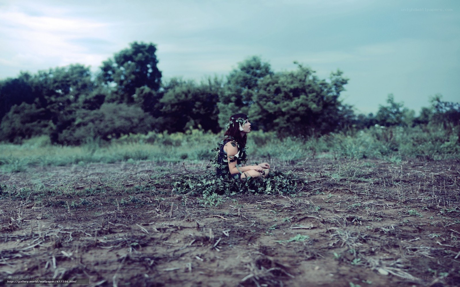 woman in leaf crown sitting