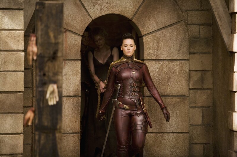 Woman in leather armor exits dungeon